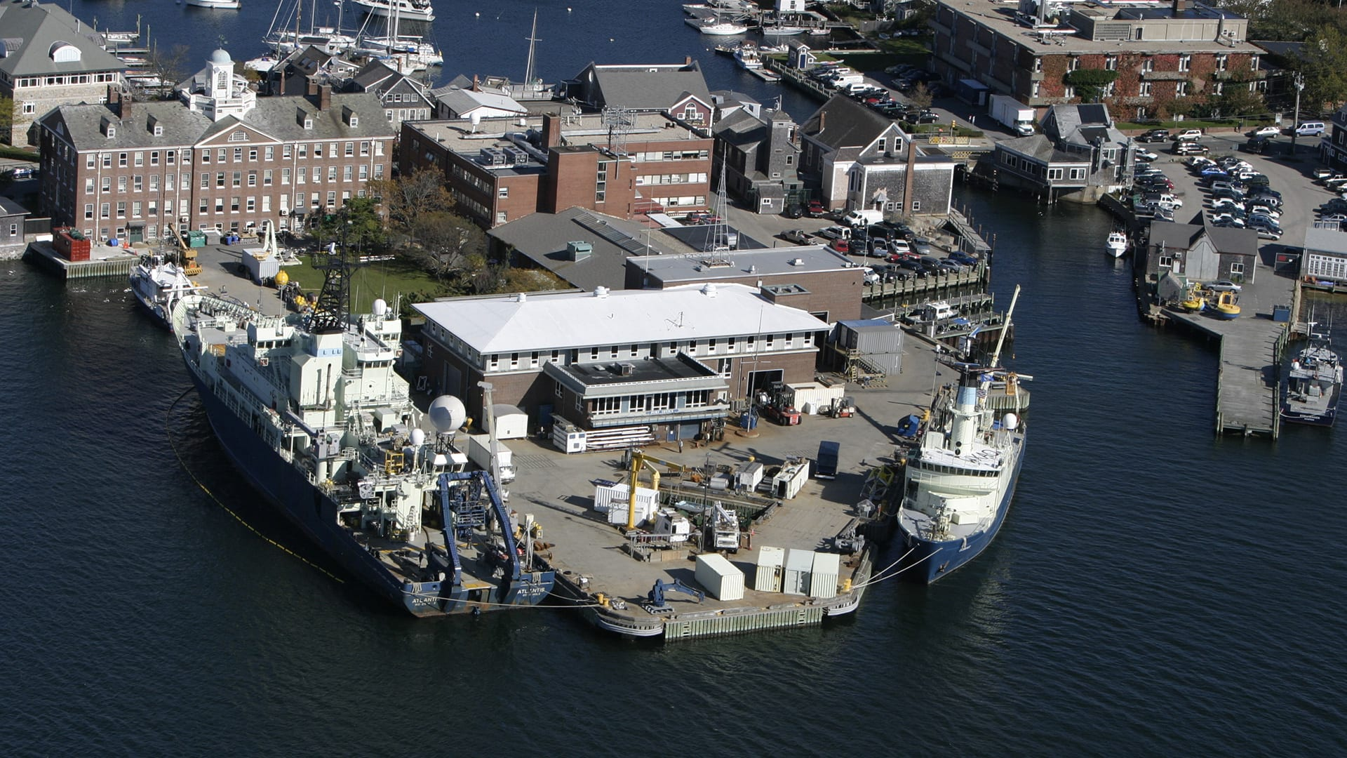 Aerial view of the buildings and wharves at the Woods Hole Oceanographic Institute, Mass.